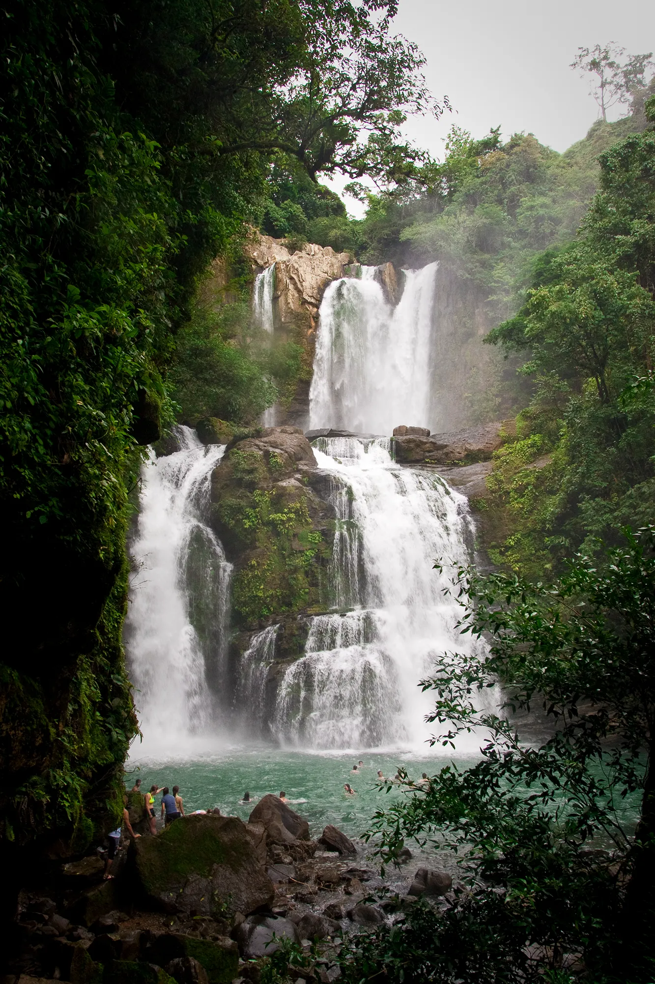A multi-tiered waterfall surrounded by rainforest in Costa Rica