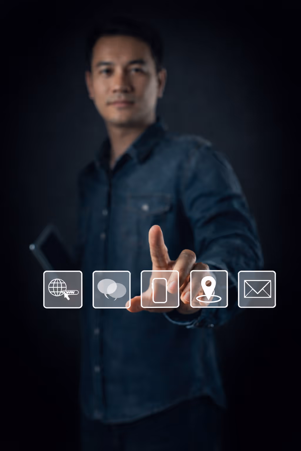 Man in denim shirt pointing to a digital contact us interface with icons for web, chat, phone, location, and email.