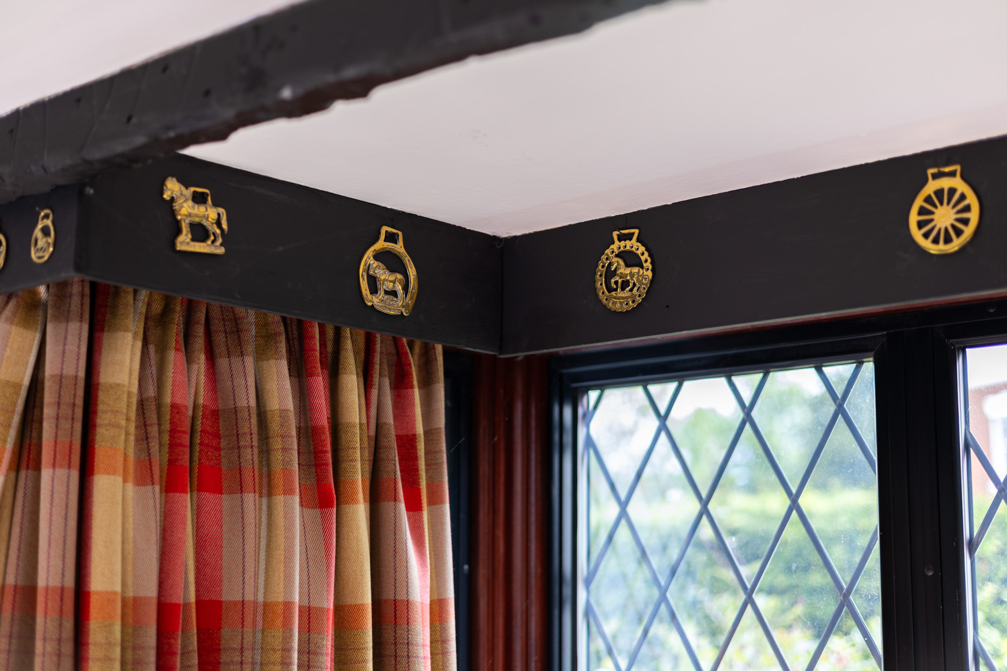 Decorative horse brasses inside the property before renovation