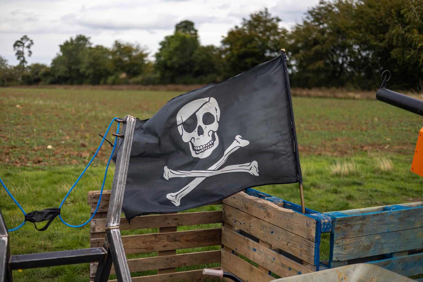 Pirate flag above wooden pallets at Overstone Grange Farm