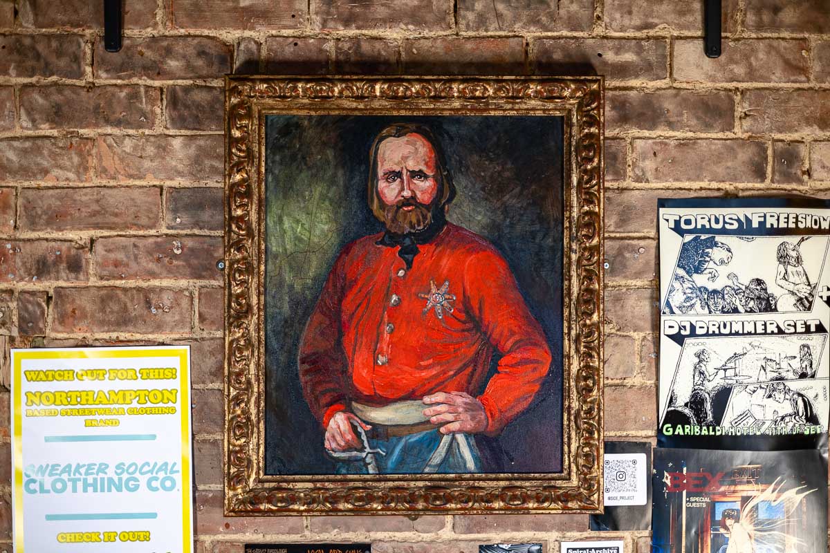 Portrait of Giuseppe Garibaldi on the brick wall inside The Garibaldi Hotel