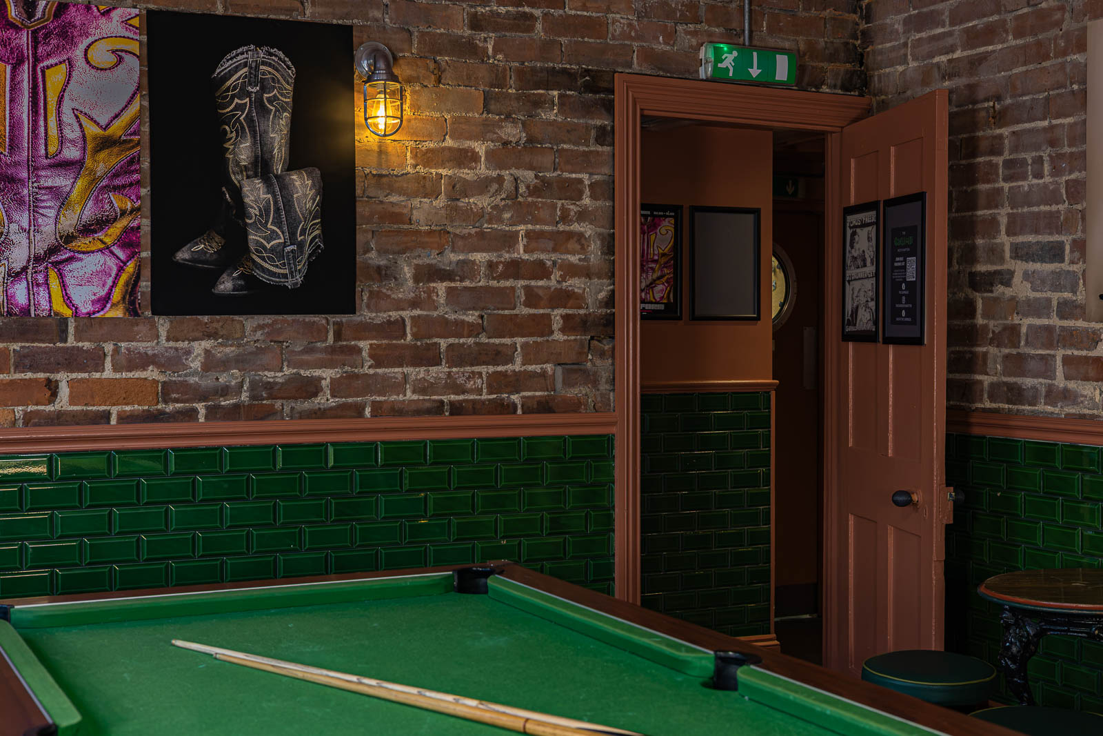 Pool table and brick wall in the games room at The Garibaldi Hotel