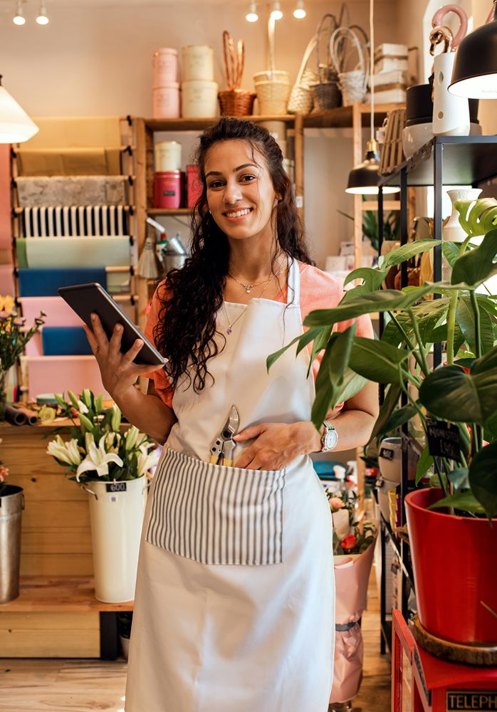 A local shop owner updating business details on a tablet
