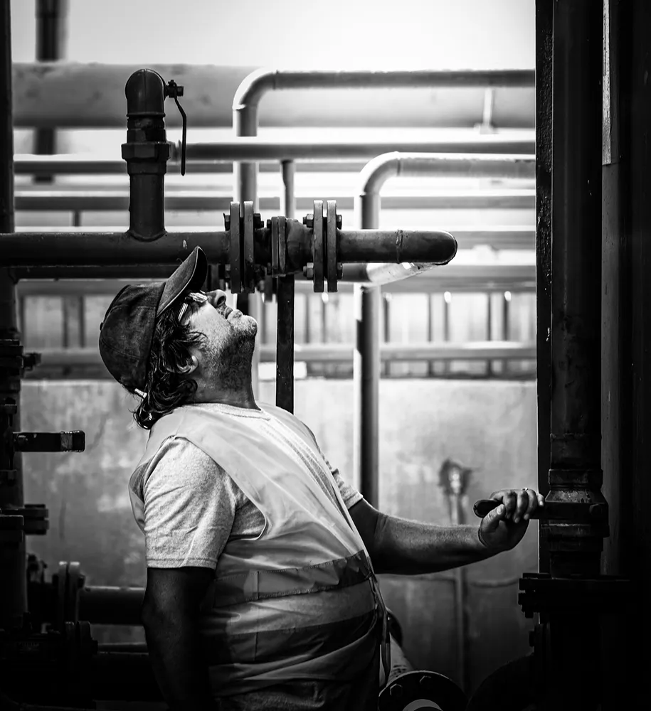 Plumber inspecting pipes and valves