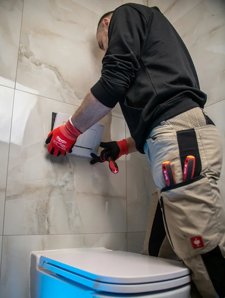 Plumber servicing a home fixture