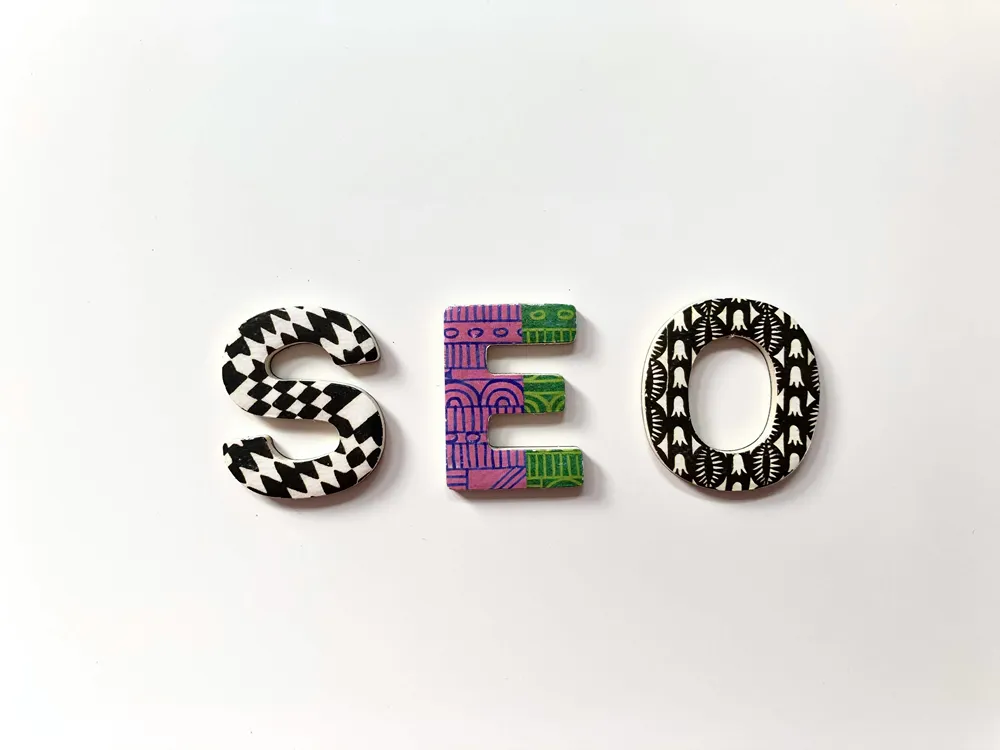 The letters SEO on a white background representing search engine optimization in a website redesign