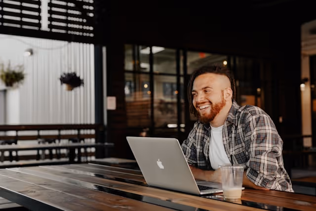 Smiling man working on laptop
