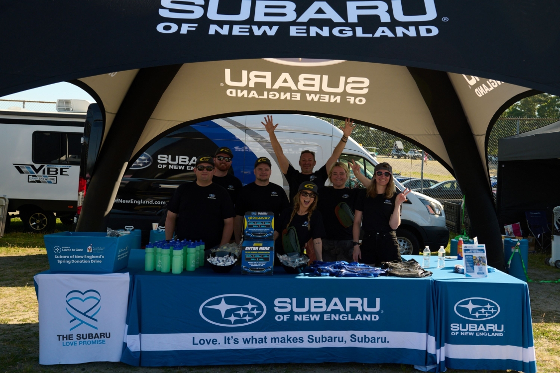 ShowMax team members at a Subaru booth hosting a ride and drive event at SubiFest.