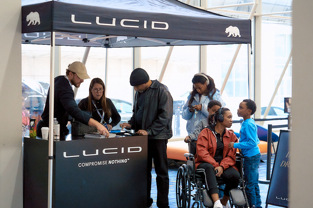 Photo of a group of individuals at a Lucid ride and drive event ShowMax managed.