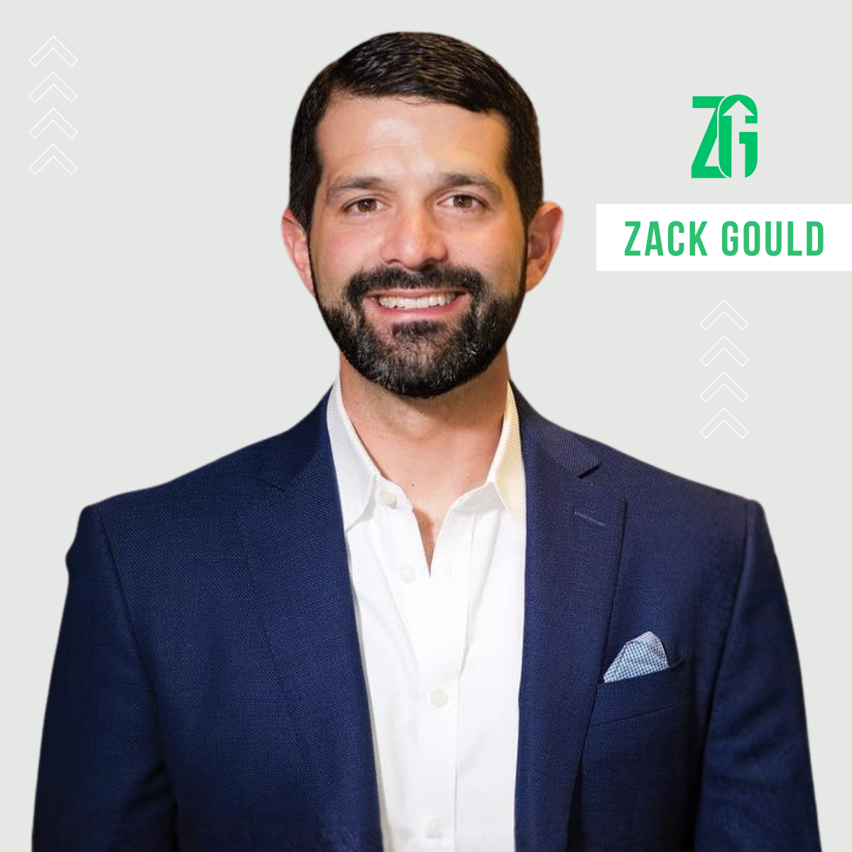 ZG Group: Zack Gould headshot profile. Smiling man with dark hair and beard wearing a navy blazer and white shirt against a light gray background with the name Zack Gould and a ZG logo.