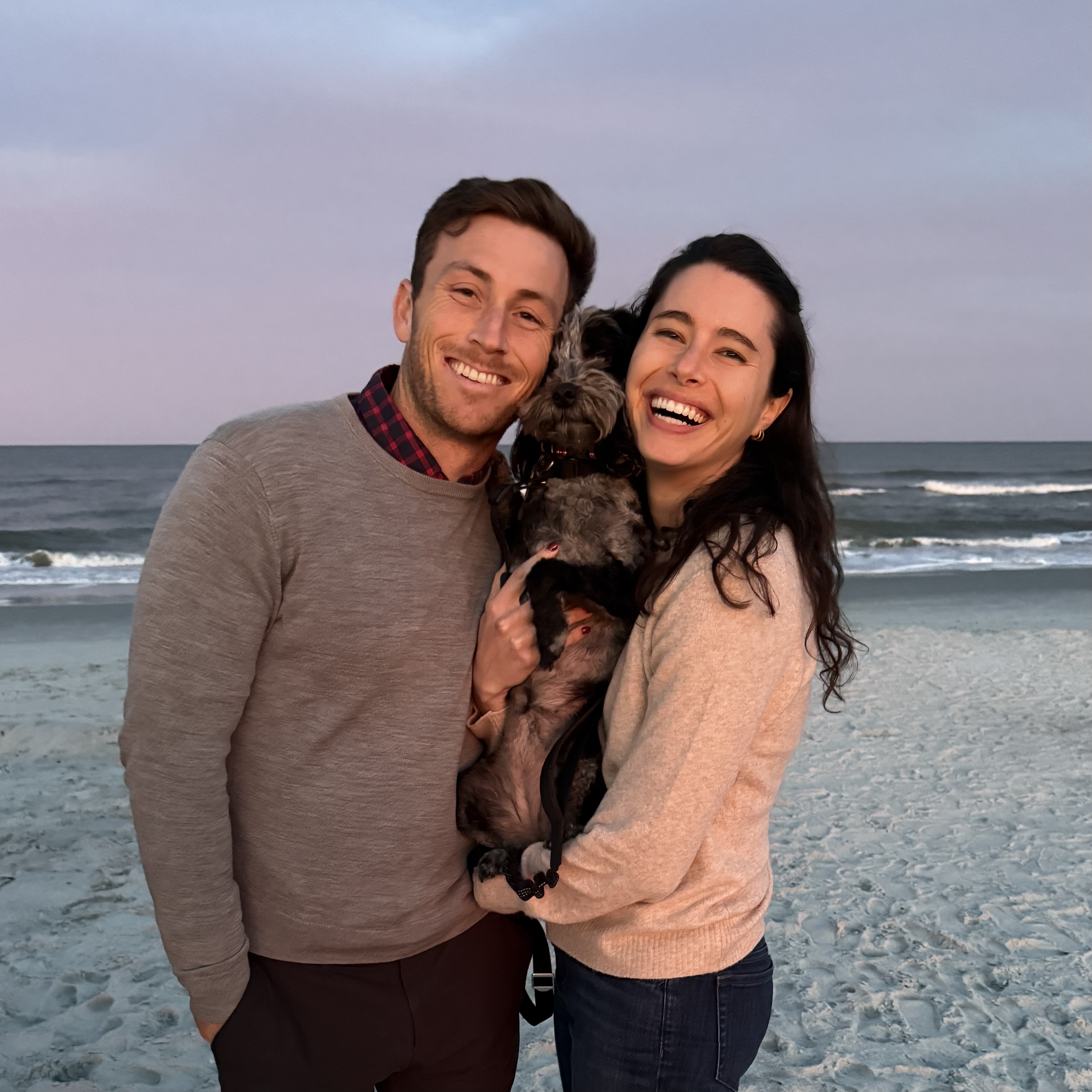 Matcha being poured in a cup, with the bamboo whisk next to it and the matcha package in the back