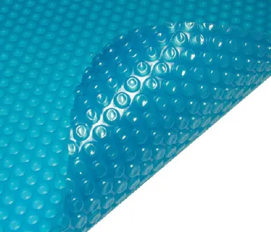 Close-up of blue bubble solar pool cover corner partially lifted.