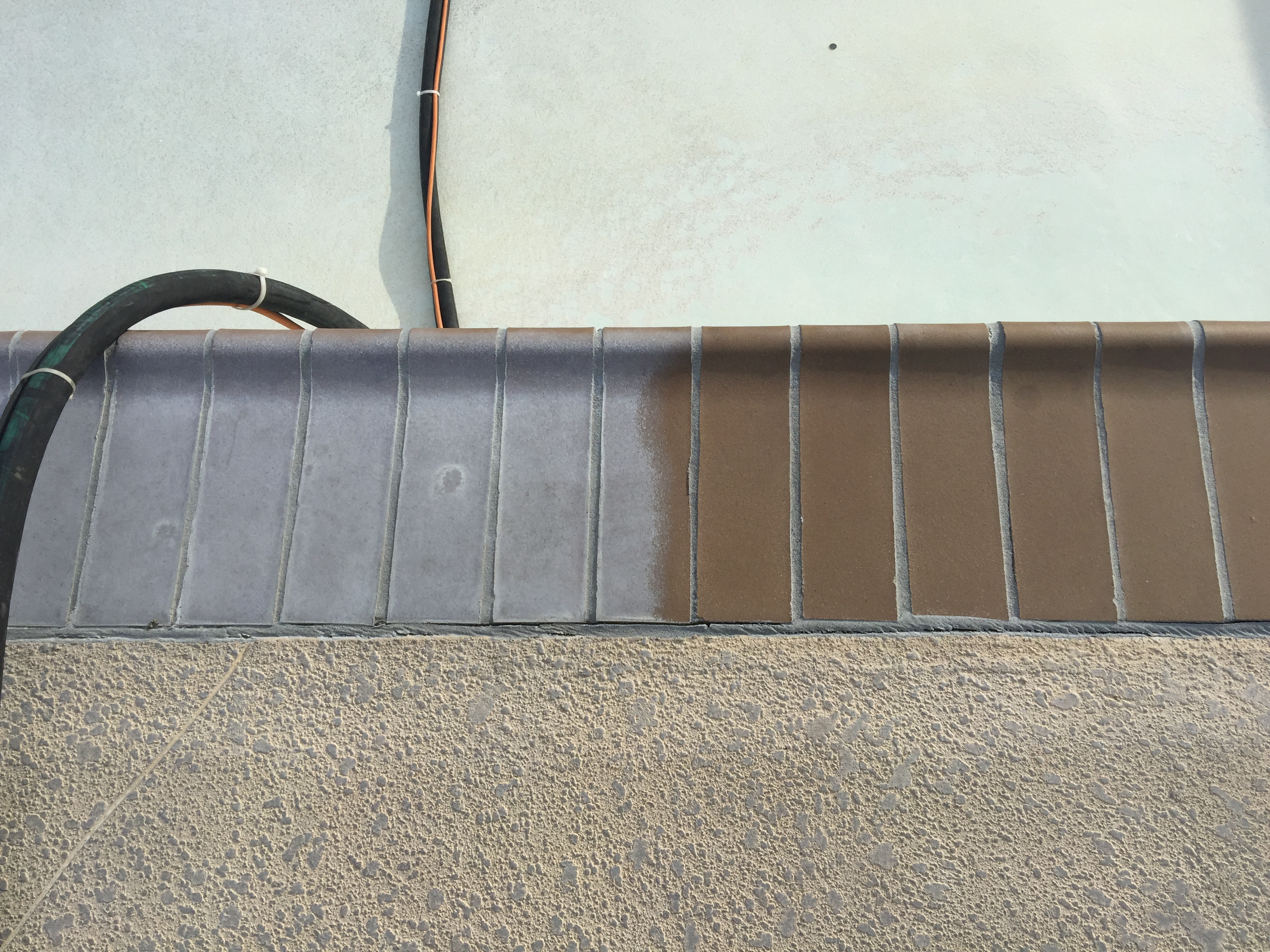 Concrete wall with precast panels and black electrical conduit pipes