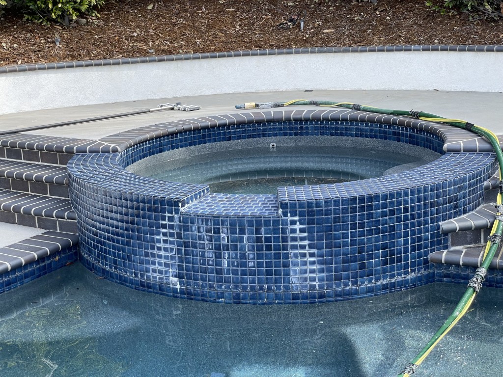 Pool Tile with Heavy Calcium Buildup