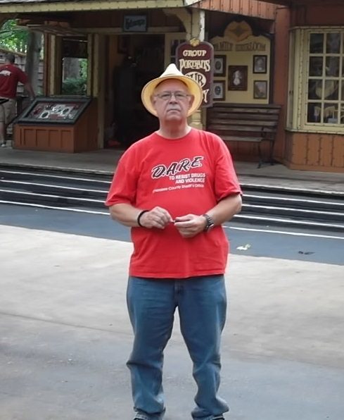 James Gary Smith wearing a yellow shirt in a warmly lit room.
