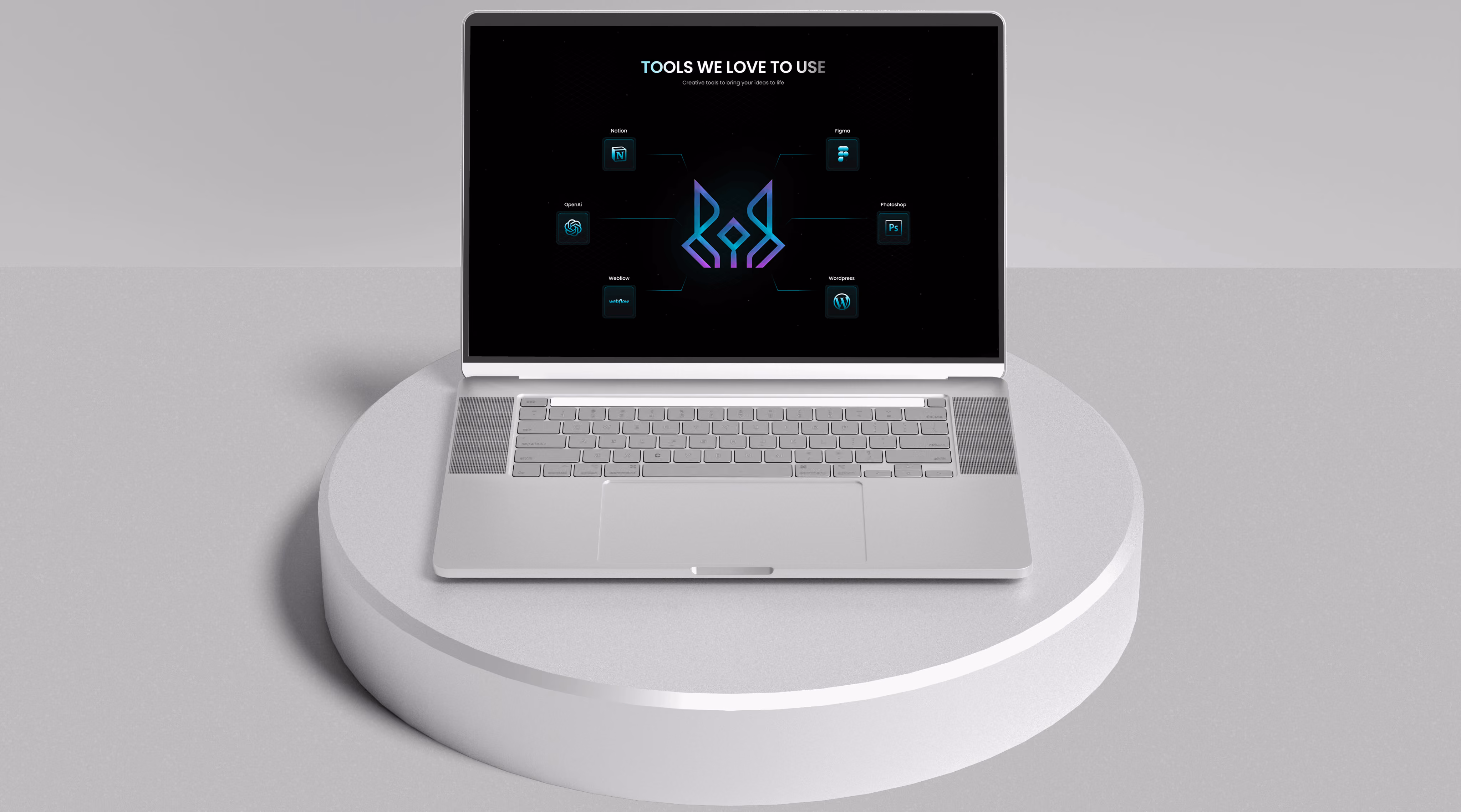 Silver laptop on a white round pedestal displaying a digital graphic titled 'Tools We Love to Use' with icons for Notion, OpenAI, Webflow, Figma, Photoshop, and WordPress.