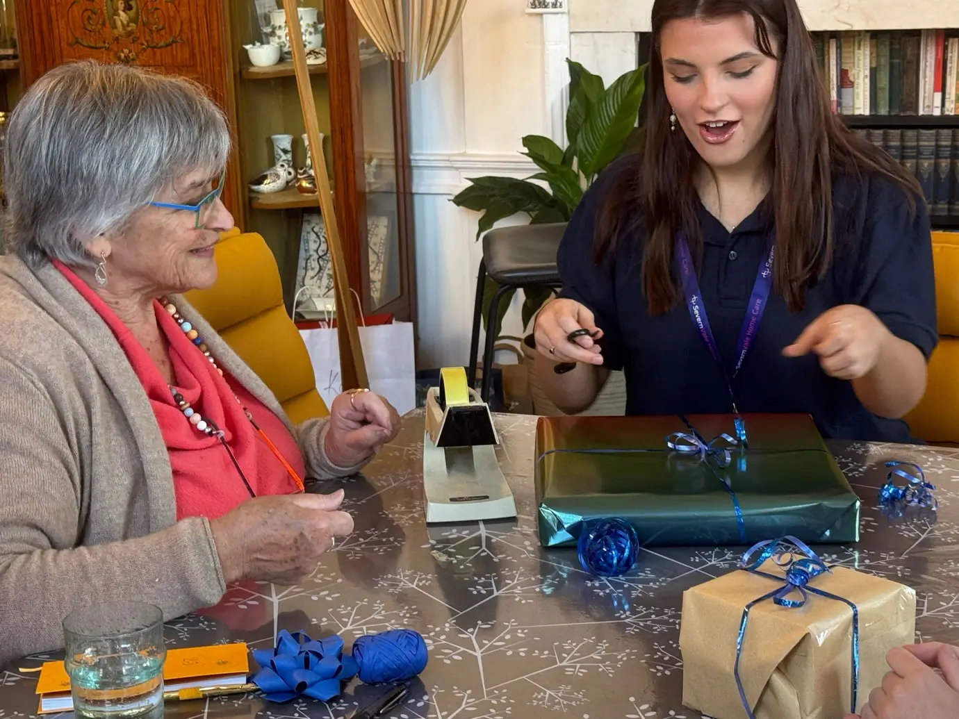Festive holiday card with a message reading 'With all best wishes to you at this festive time of year,' surrounded by decorative snowflakes and a winter-themed postcard in the background.