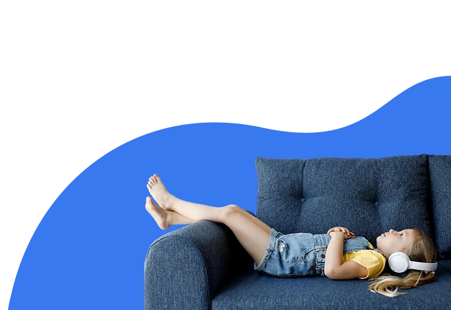 A girl with a headset relaxing on a sofa