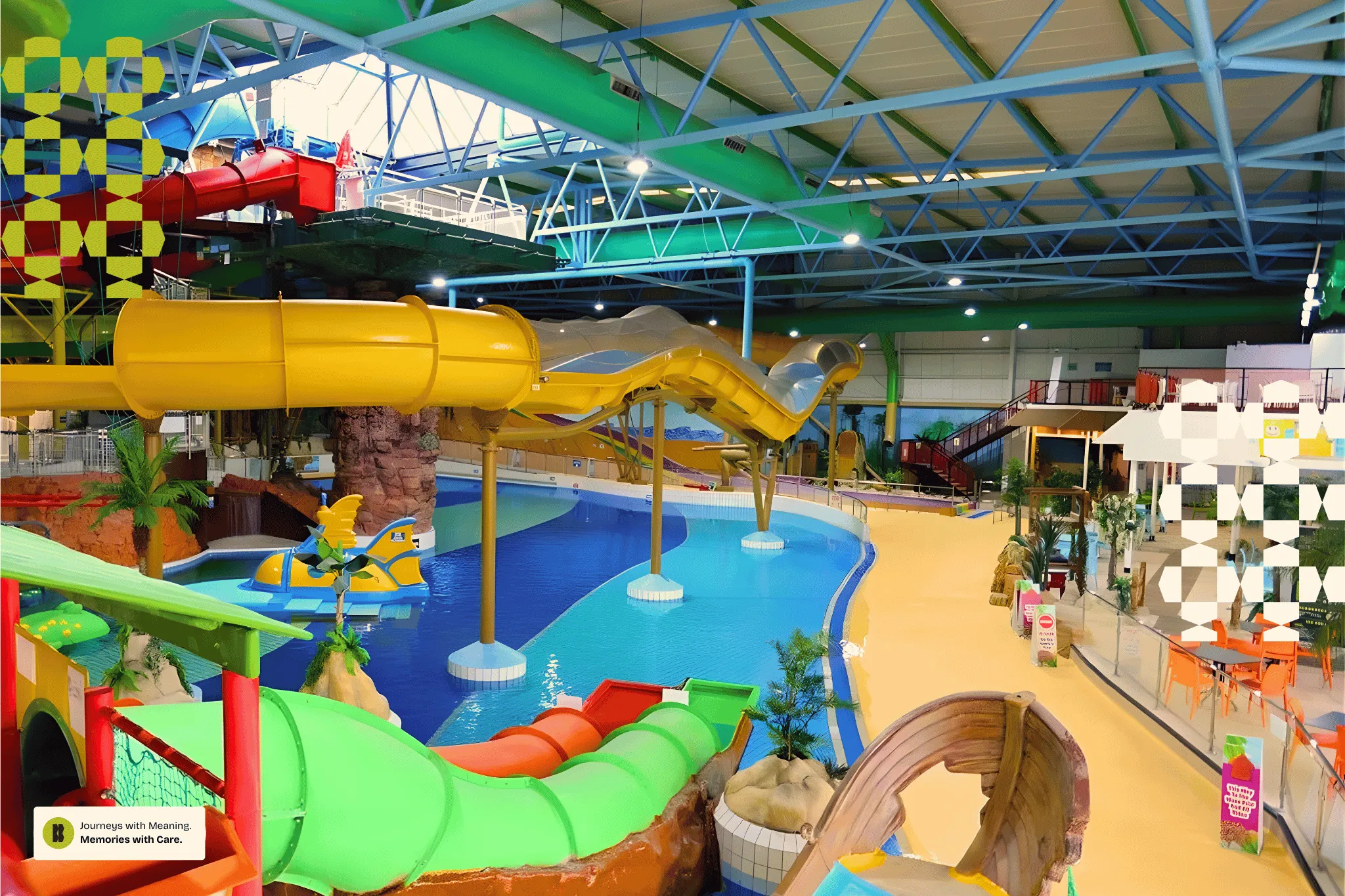 Indoor water park featuring colorful water slides including green, yellow, red, and silver slides leading into a large pool with surrounding seating and play areas.