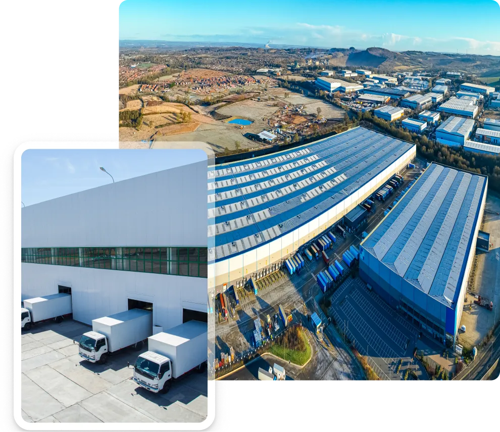 Aerial view of a large industrial warehouse complex with numerous loading docks and trucks, set in a semi-rural area with fields and hills in the background.
