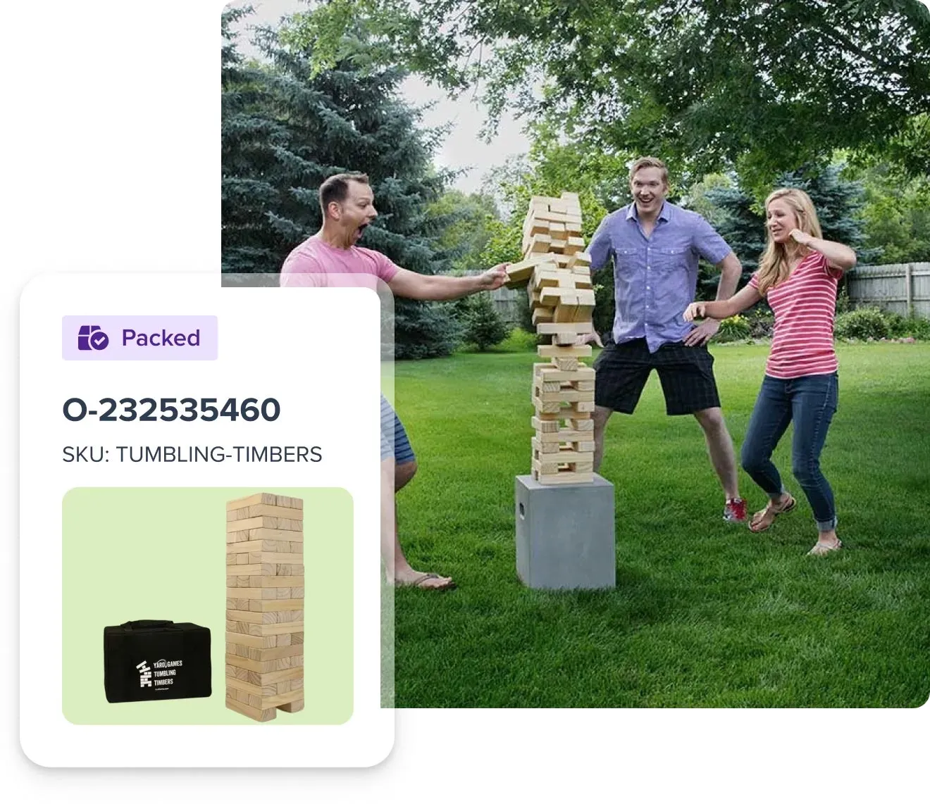 Three people outdoors playing a large wooden block stacking game with a tower toppling over.