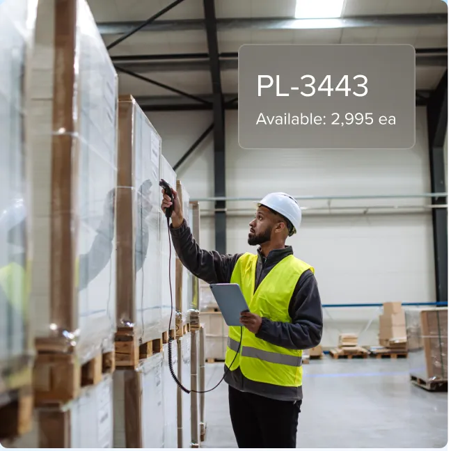 Warehouse worker in a safety vest and helmet scanning items on pallets with a handheld scanner and holding a tablet, with inventory data showing product code PL-3443 and availability of 2,995 units.