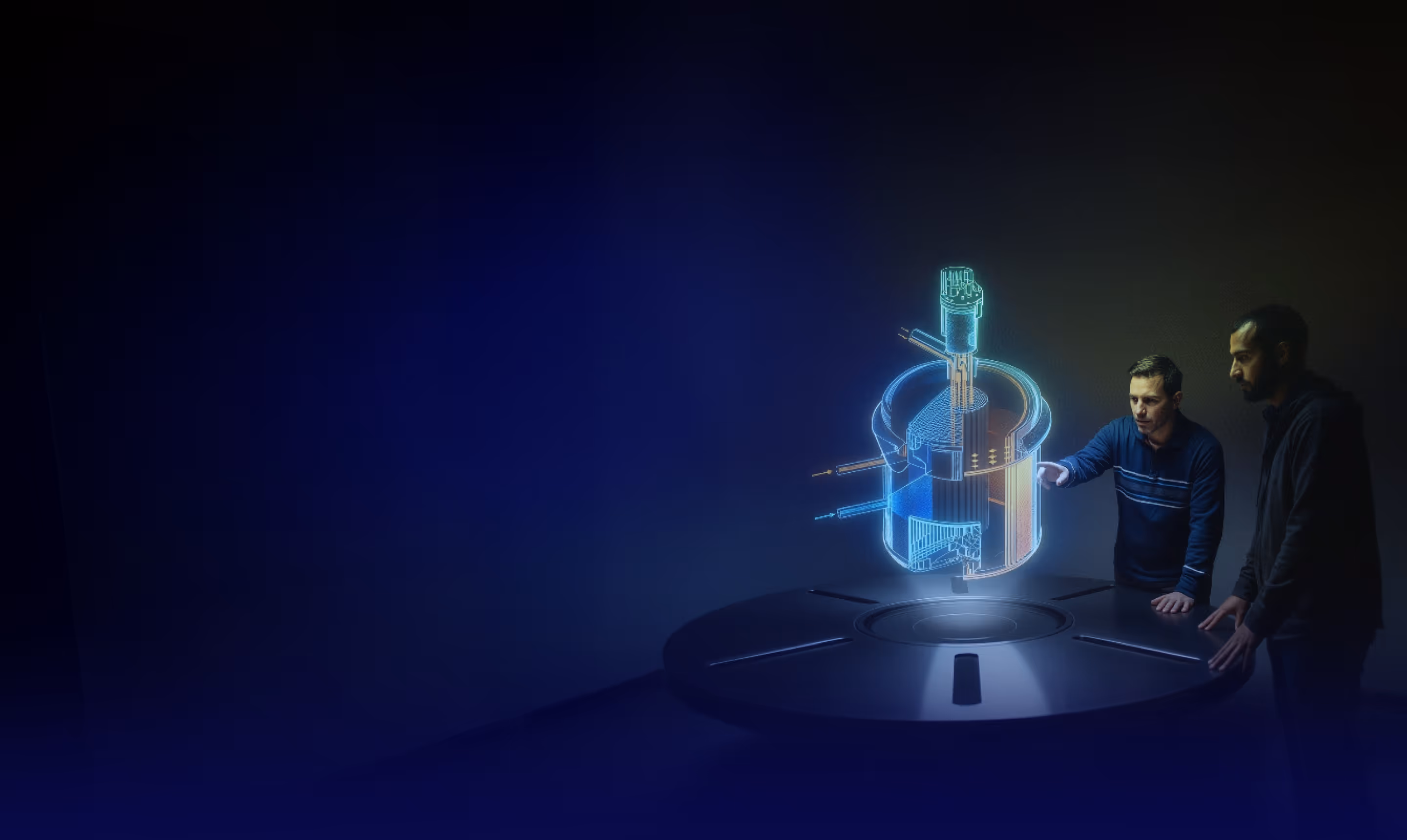 Two men examining a holographic 3D technical model projected above a round table in a dark room.