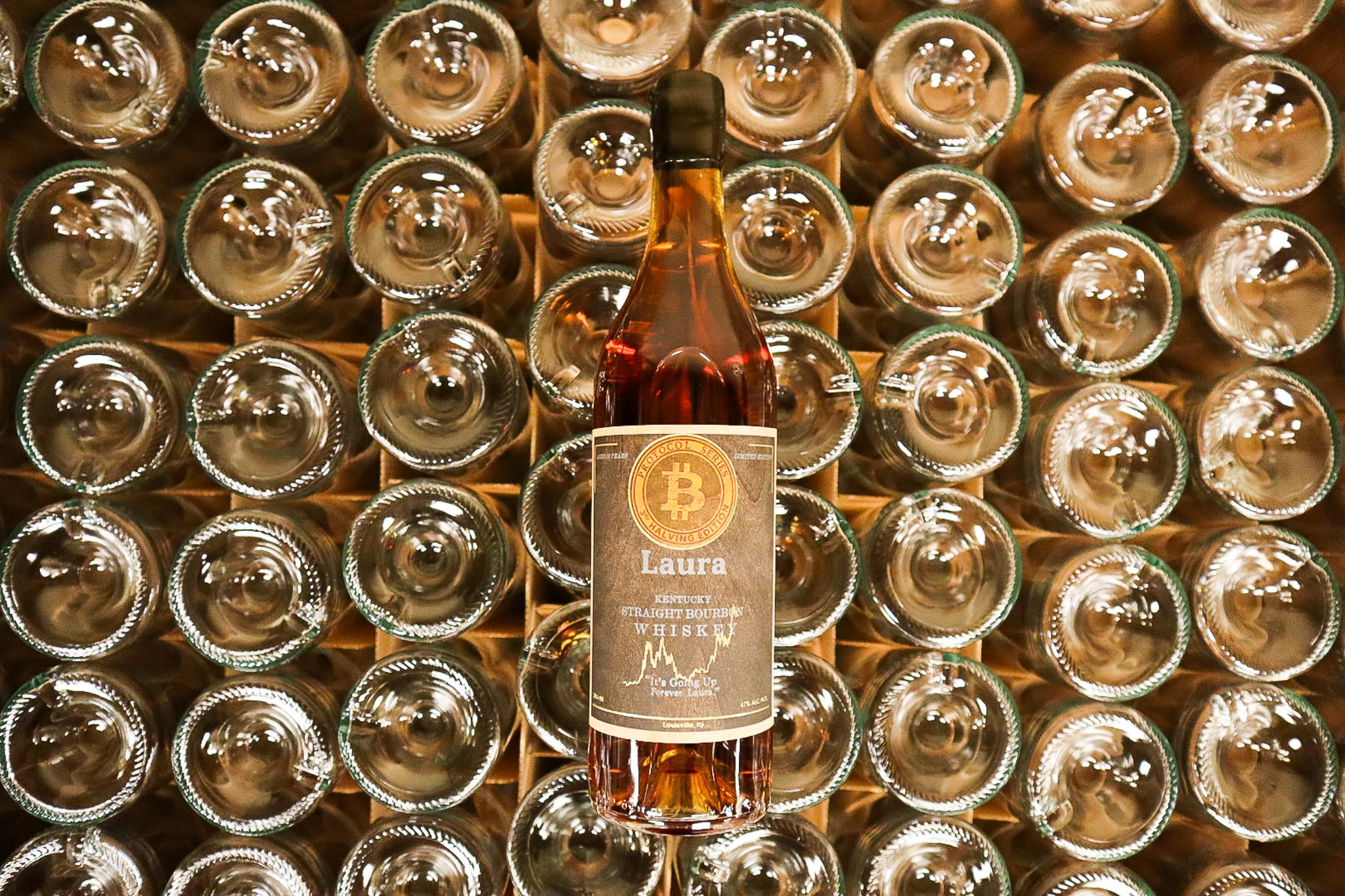 Laura Bourbon Bottle On Top Of Wine Glasses