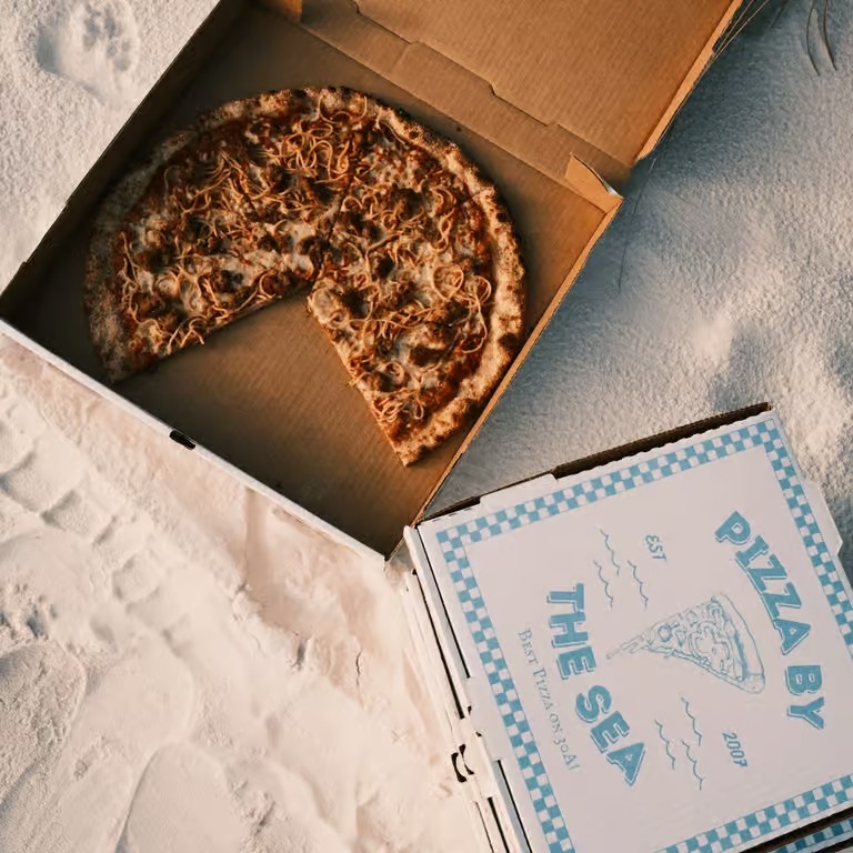 Pizza by the Sea pizza boxes and pizza on the beach along 30A Florida