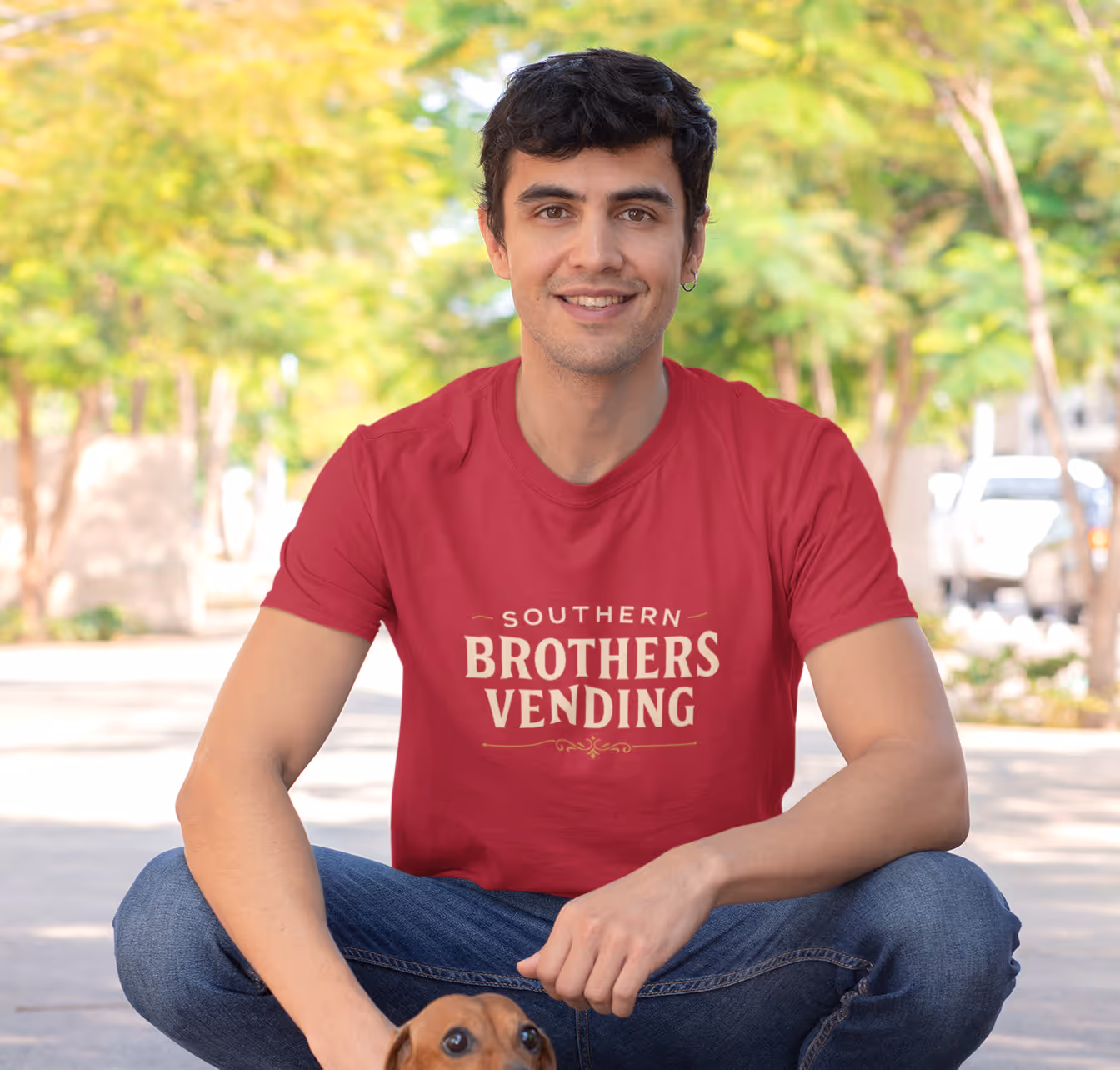 Customer seated wearing a red custom printed t-shirt demonstrating comfort and style.