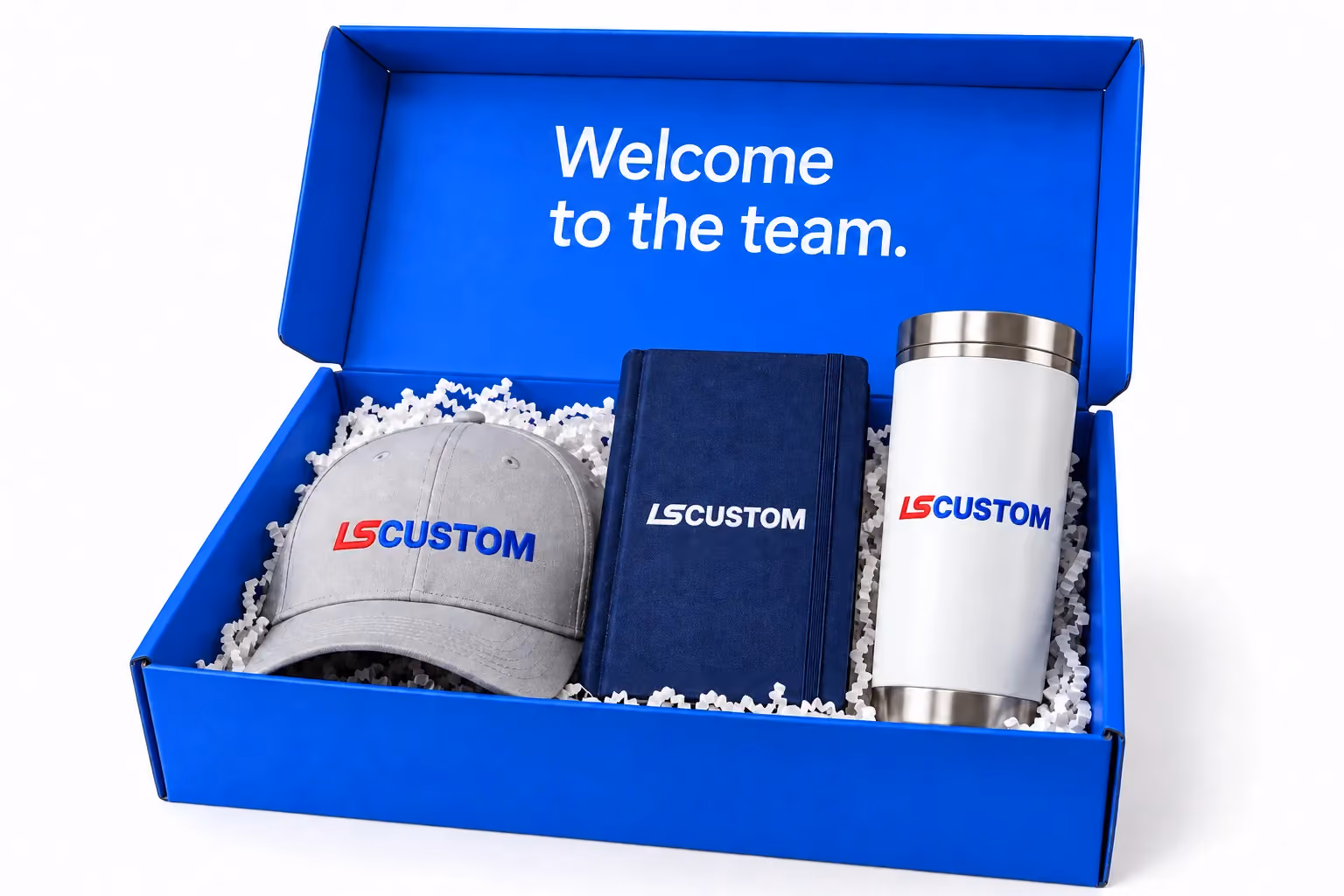 Royal blue welcome kit with a gray cap, navy notebook and white tumbler