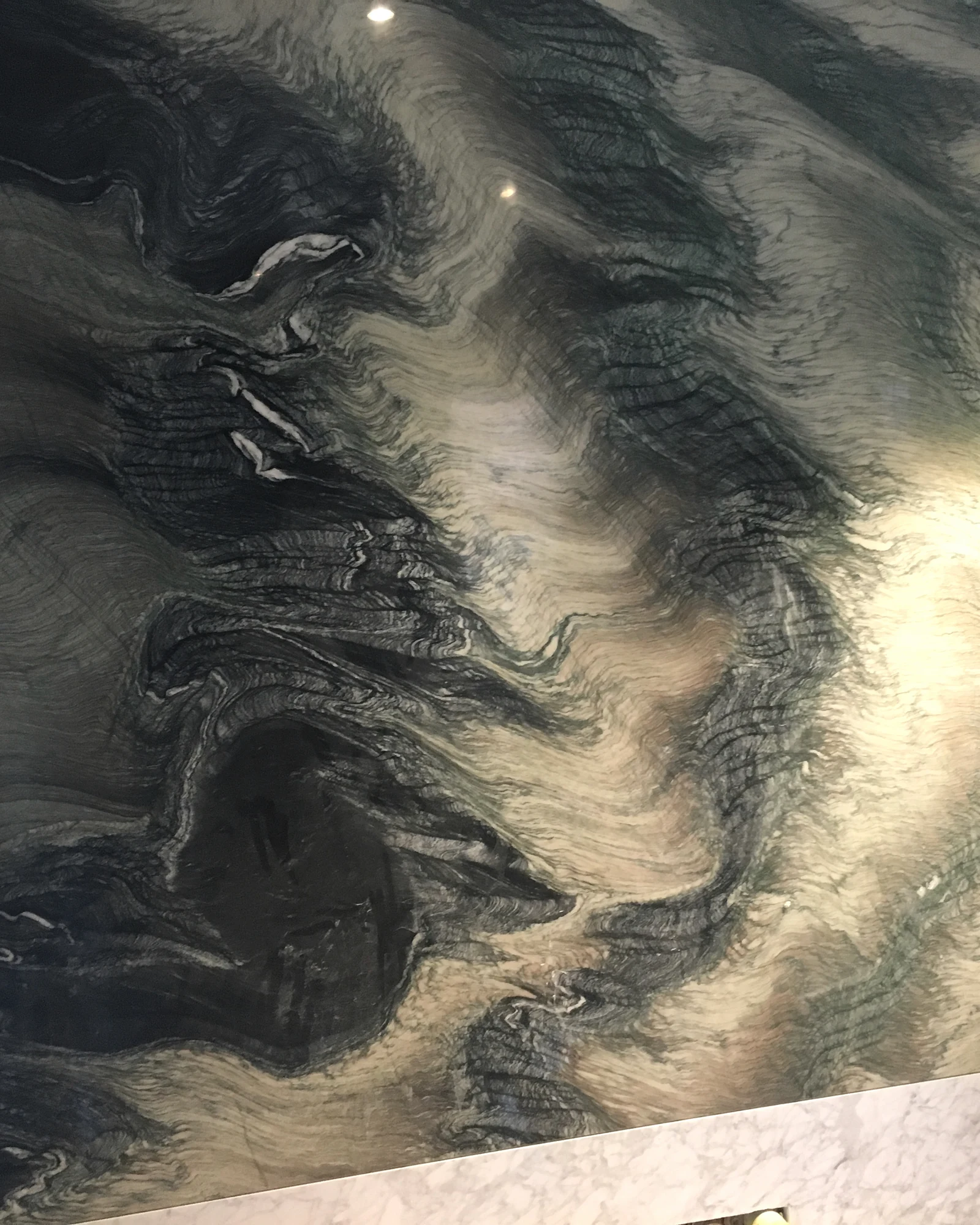 Veined stone feature wall during installation at the Regent’s Park Residence