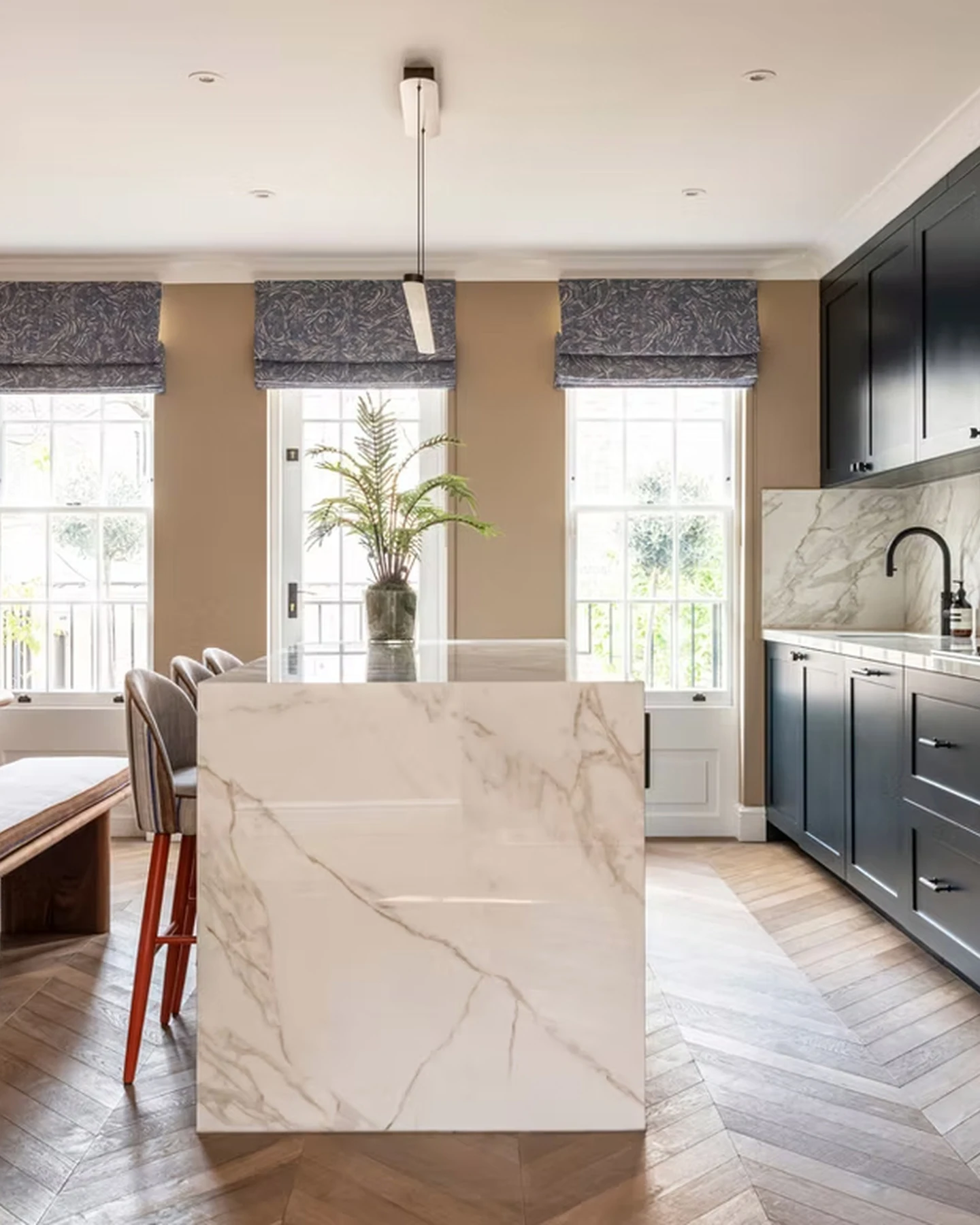 Porcelain kitchen island and dark cabinetry at Bourne Street, Belgravia