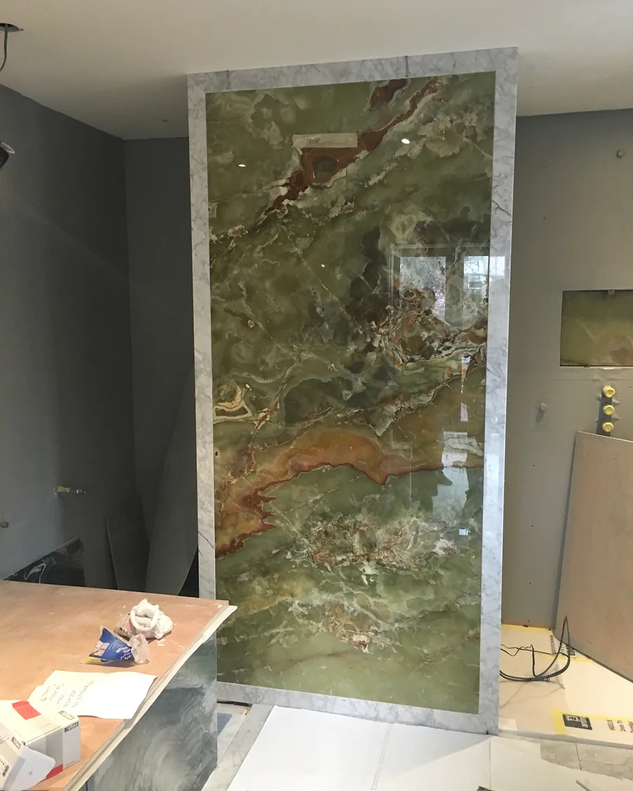 Regent’s Park Residence · Green stone feature panel within the room — installation photographs