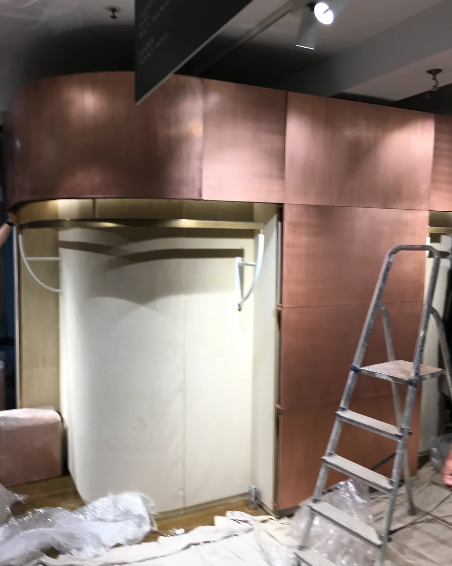 NU at Liberty · Curved display surround during installation — installation photographs