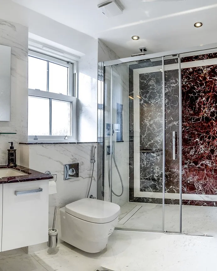 Marble & stone · Shower enclosure with a dark stone feature panel