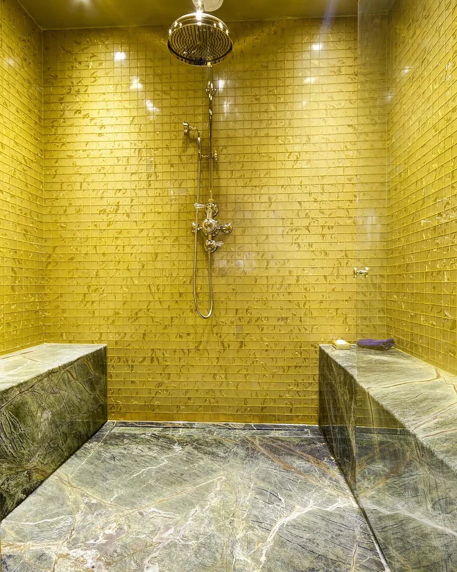 Marble & stone · Stone benches and mosaic shower walls