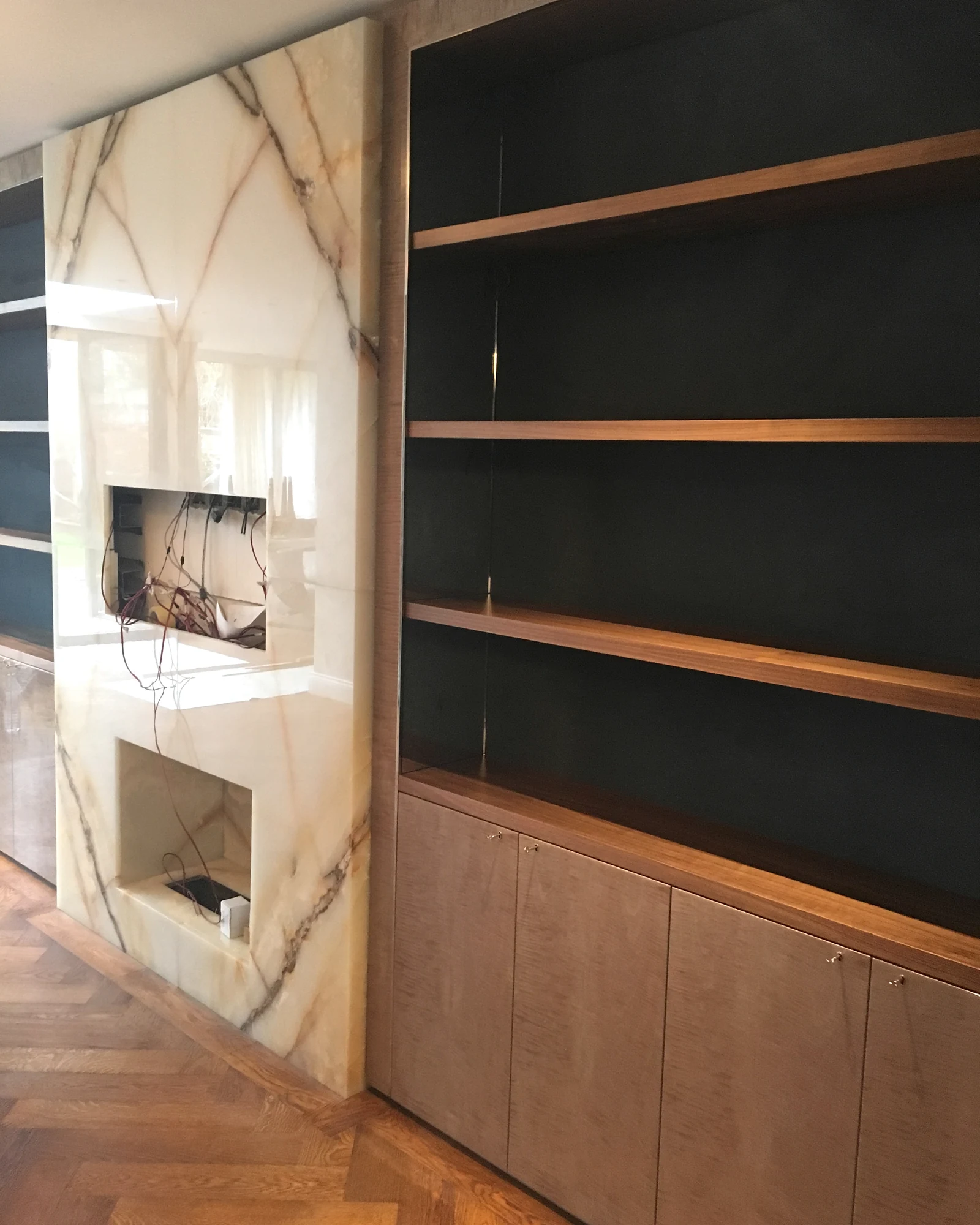 Fitted shelving and fireplace surround during installation