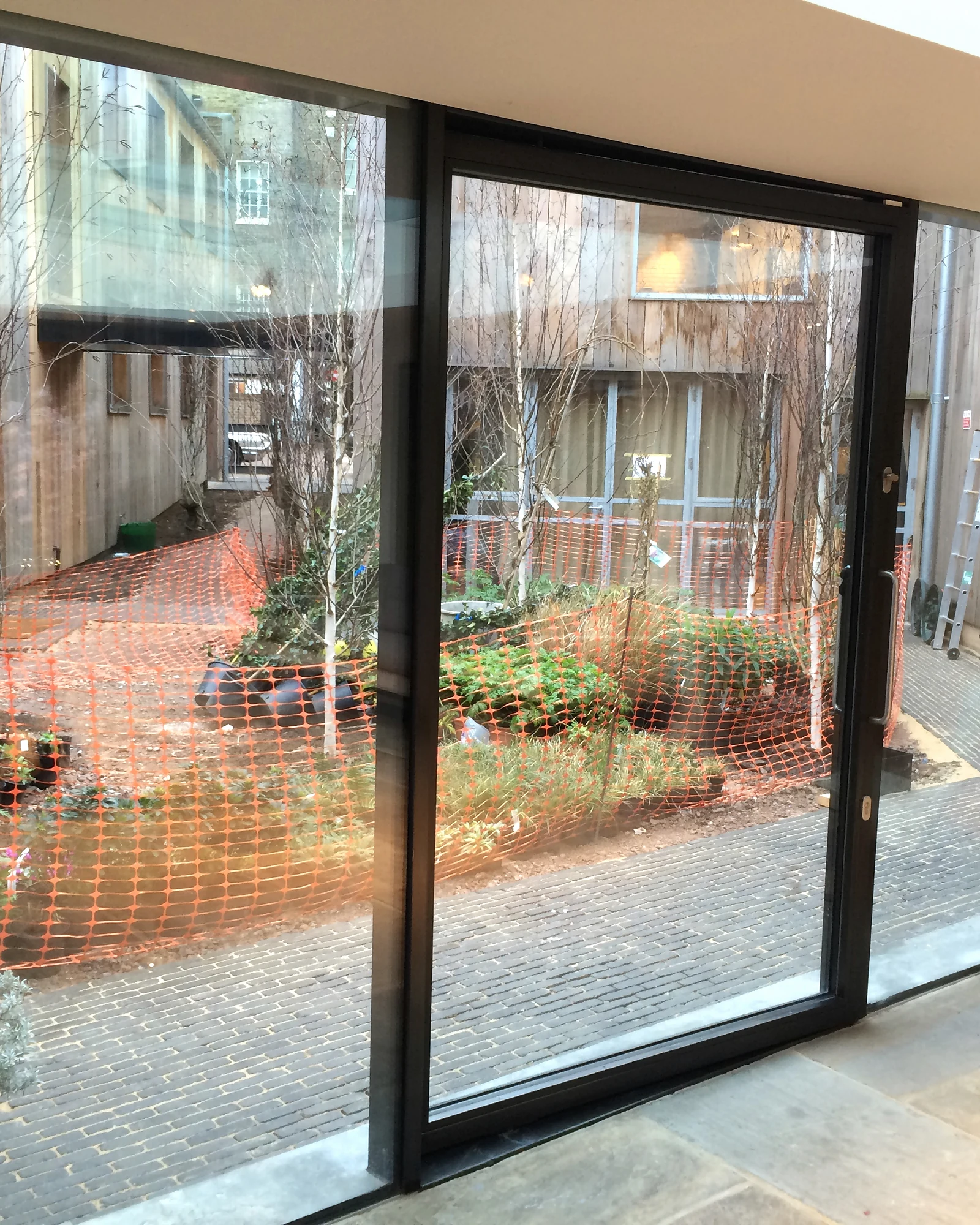 Full-height glazing between an interior and its garden