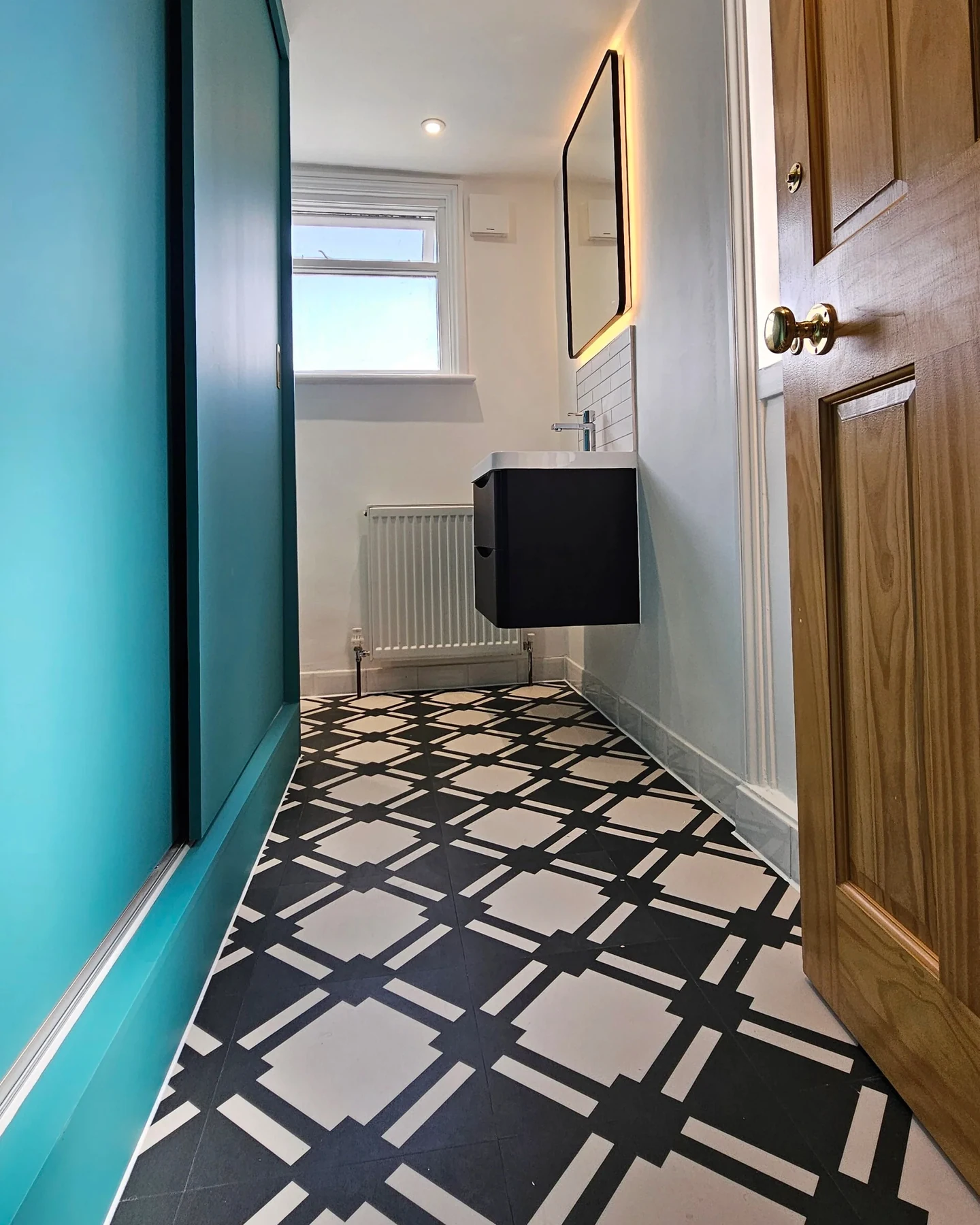 Patterned hallway flooring and painted walls in the Highbury house