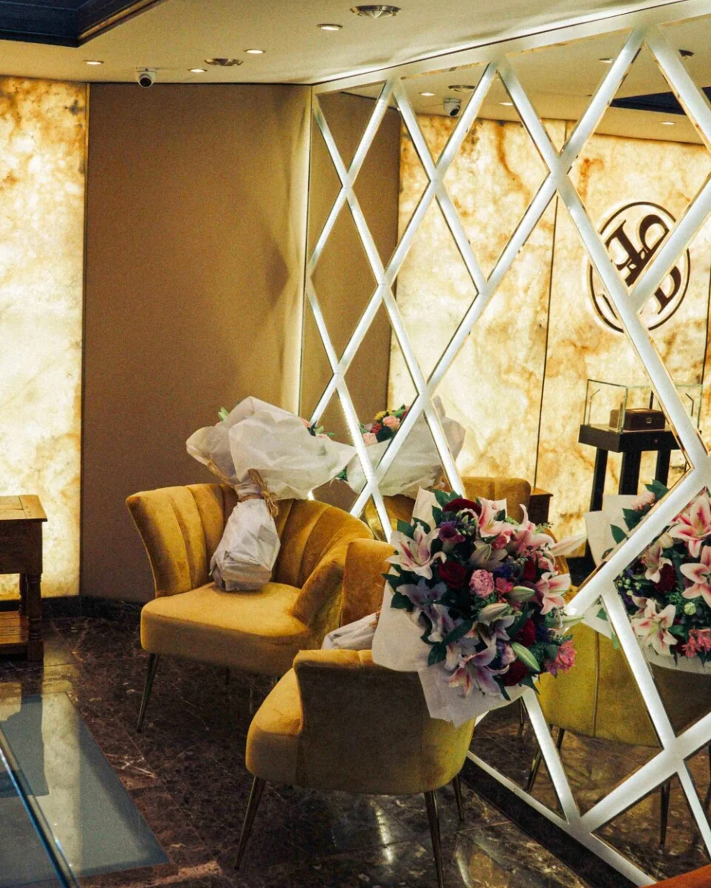 Jeweller’s boutique with illuminated onyx, display counters and mirrored detailing