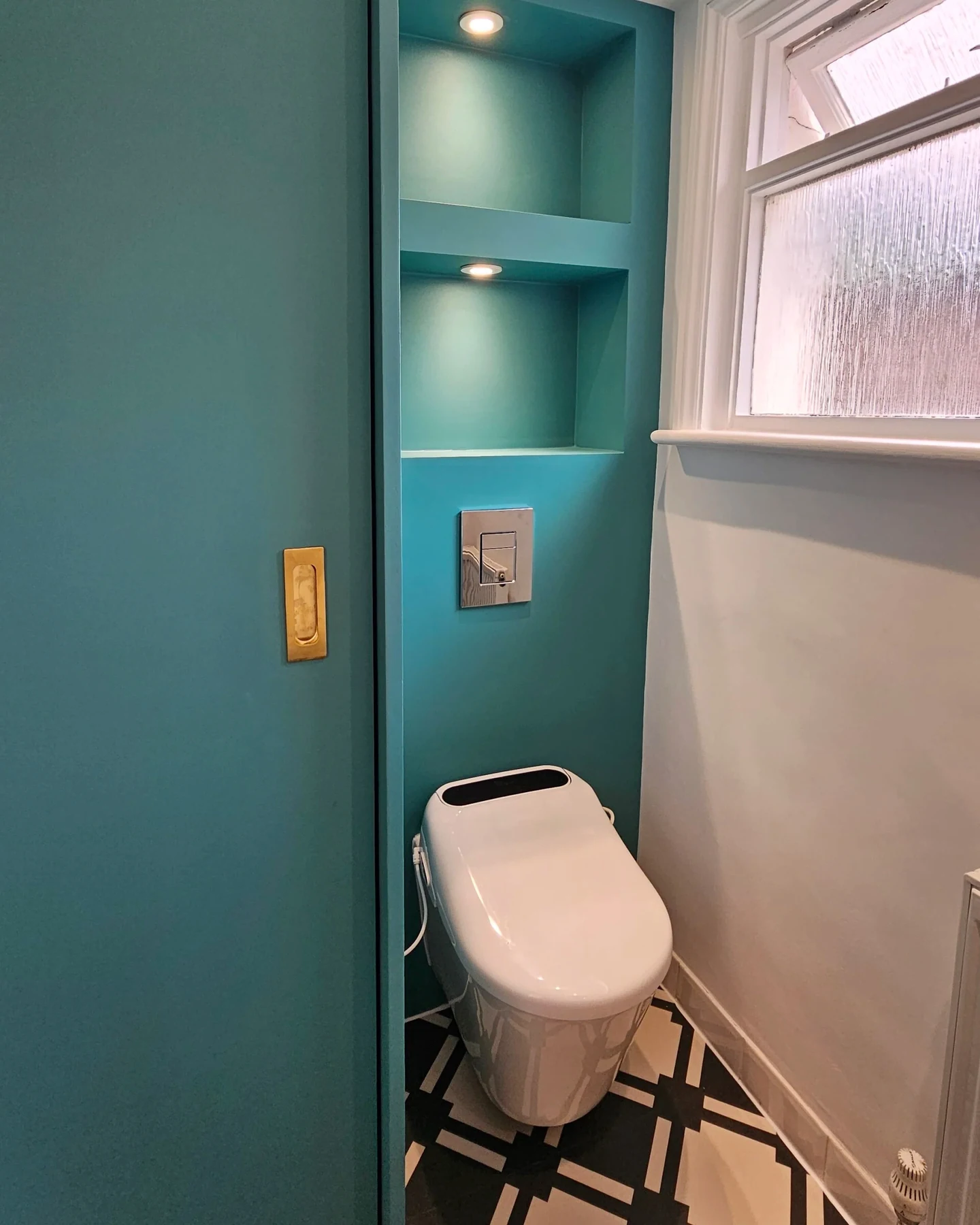Fitted storage and window detail in the cloakroom