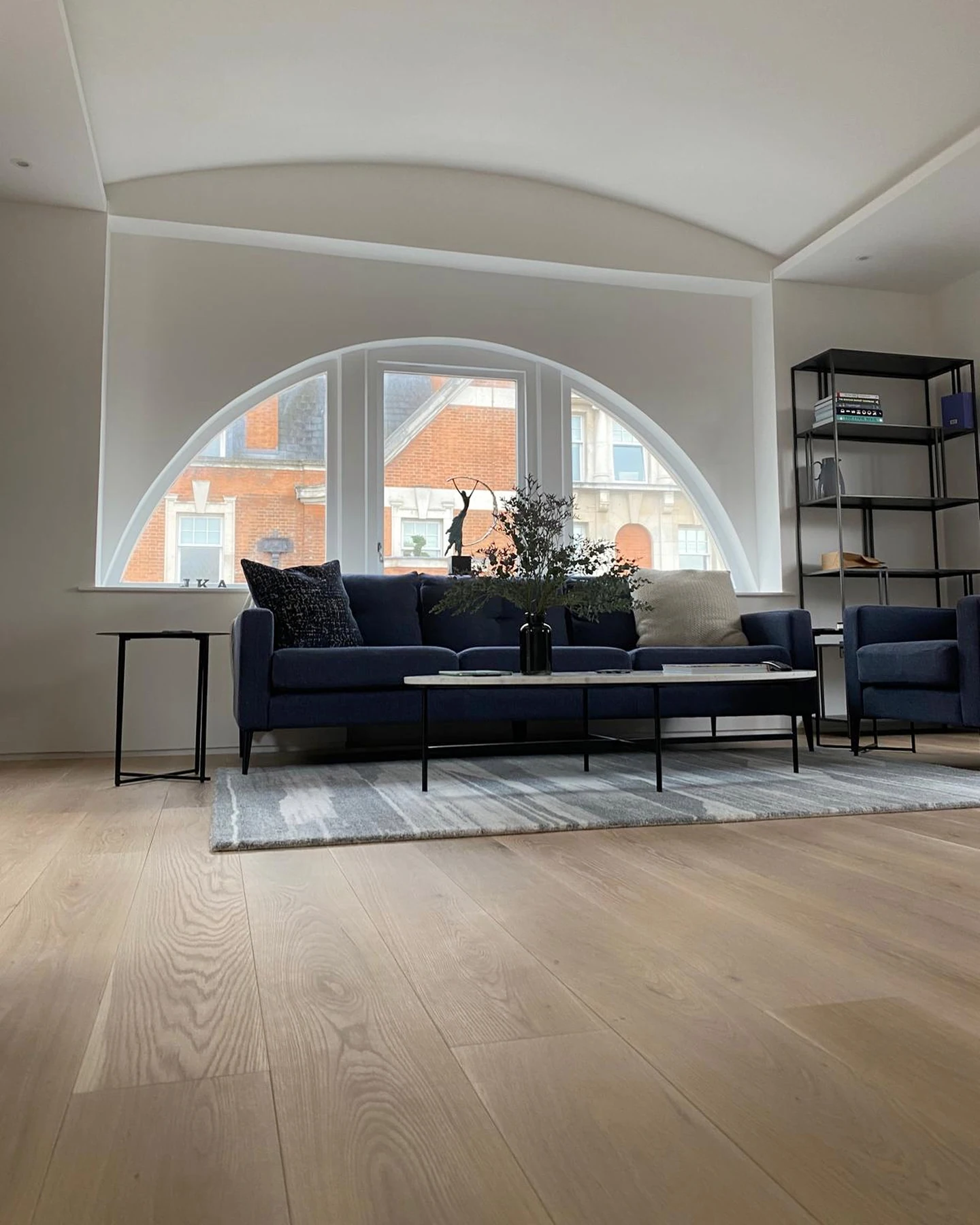 Living room beneath the broad arched window