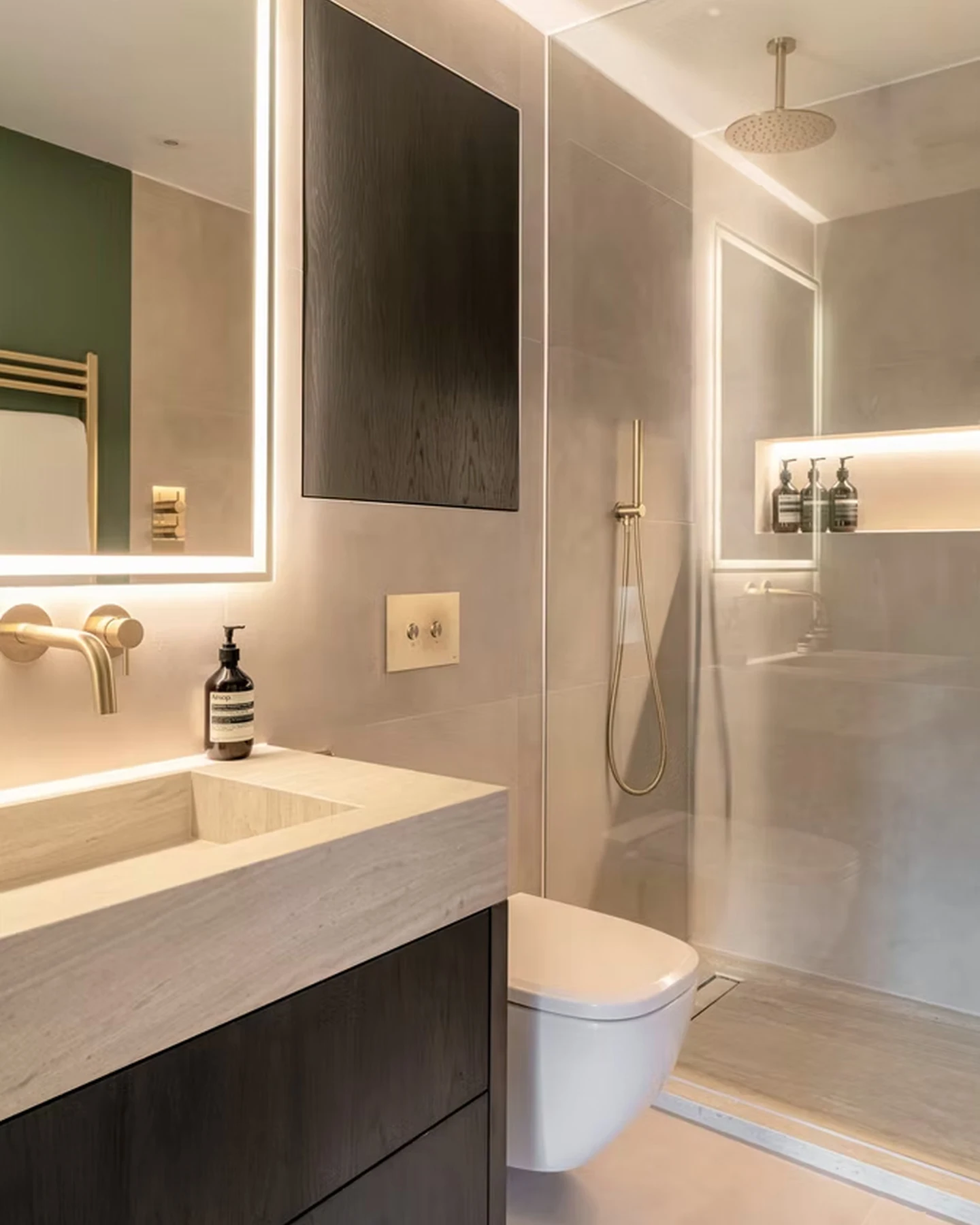 Bathroom with illuminated mirror and integrated storage
