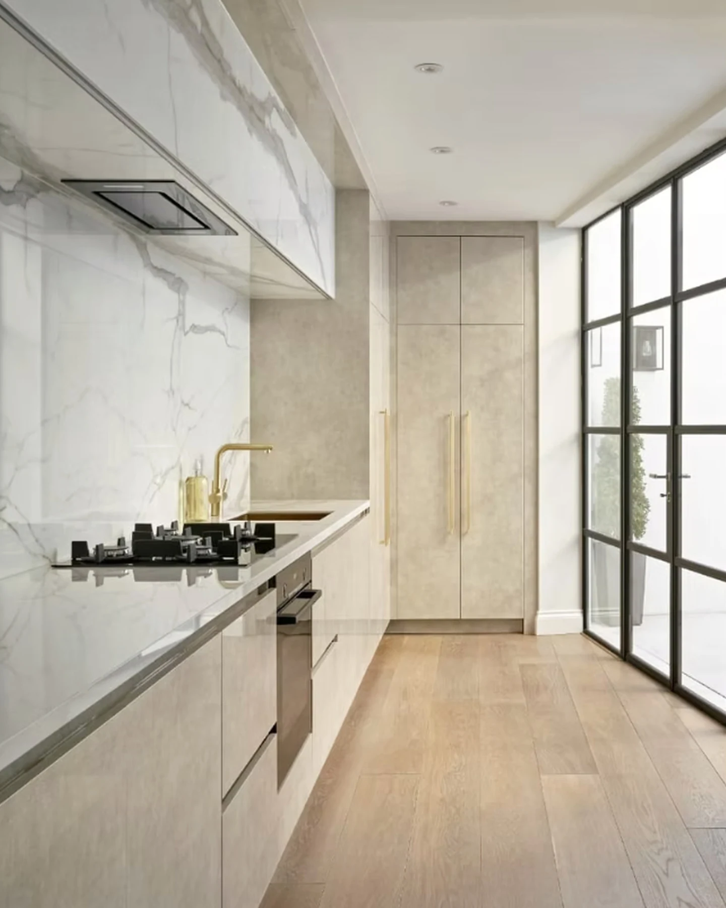 Knightsbridge kitchen with veined surfaces and glazed doors