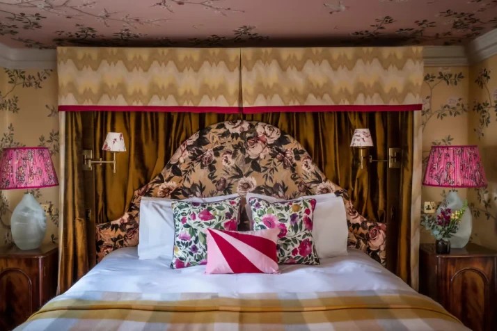 Luxury bedroom interior at Glenmorangie House with patterned furnishings and soft lighting.