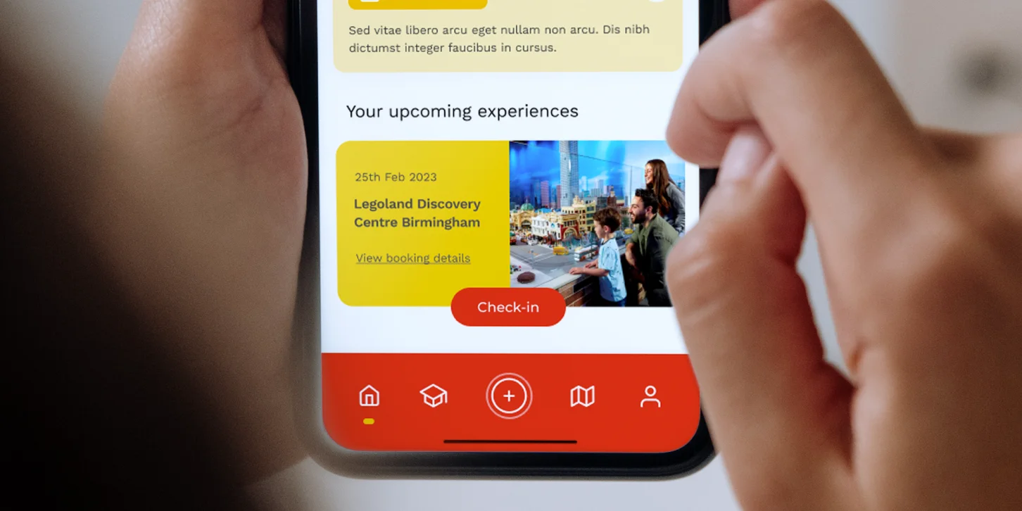 Person using a mobile app showing upcoming bookings for LEGOLAND Discovery Centre Birmingham with check-in options.