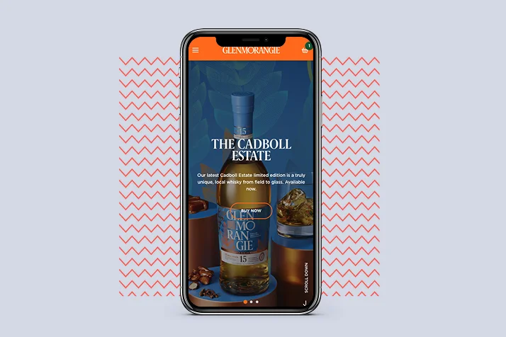 Smartphone screen showing Glenmorangie website featuring The Cadboll Estate whisky bottle with buy now button and description.