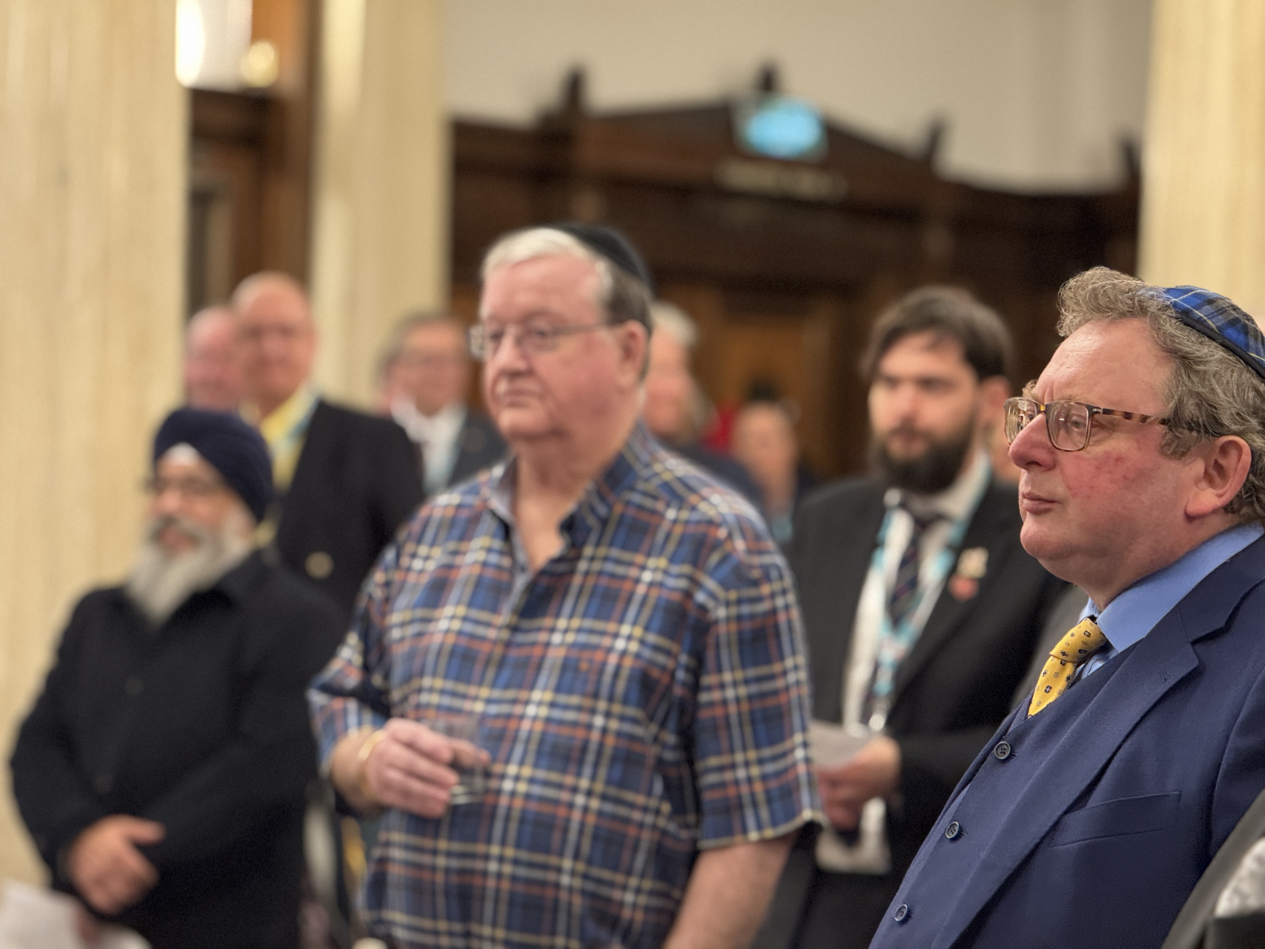 Diverse group of men in religious attire standing together indoors