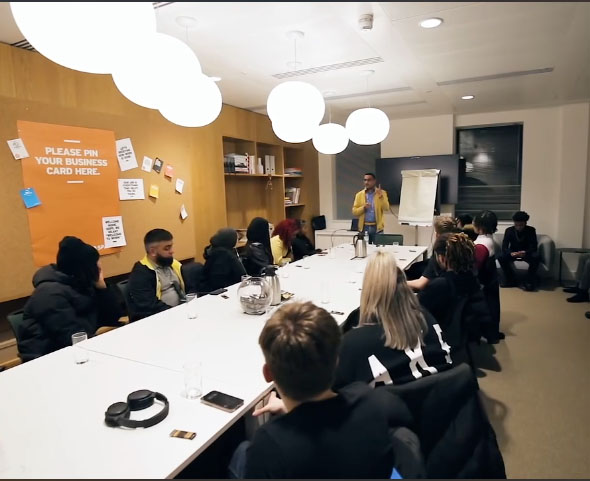 image of a diverse group of professionals in a meeting room for a digital marketing & advertising agency